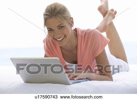 A young woman working on a laptop View Large Photo Image Stock Image - A young woman working on a laptop. Fotosearch