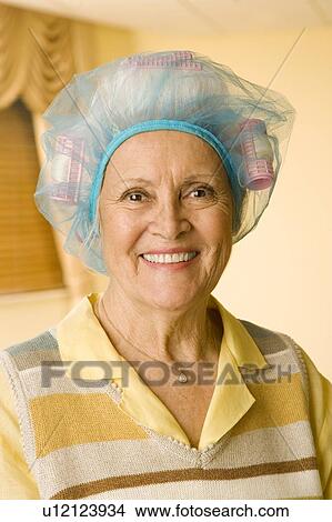 Picture - An elderly woman wearing curlers. Fotosearch