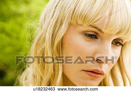 Stock Image - Beauty portrait of a woman in a tropical setting.. Fotosearch