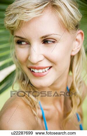 Stock Photo - Beauty portrait of a woman in a tropical setting.. Fotosearch