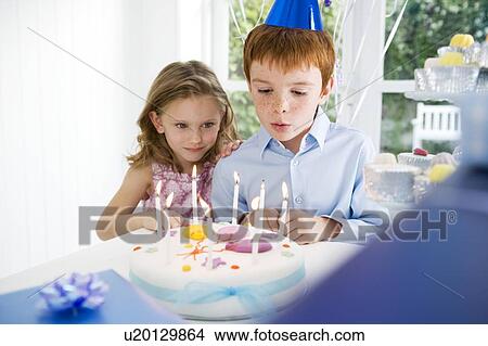 boy blowing out candles on birthday cake View Large Photo Image Picture - boy blowing out candles on birthday cake. Fotosearch