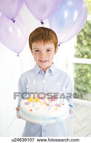 Stock Photo - boy carrying birthday cake. Fotosearch