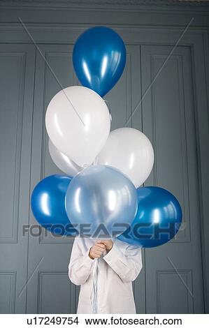 boy hiding behind a bunch of balloons View Large Photo Image Picture - boy hiding behind a bunch of balloons. Fotosearch