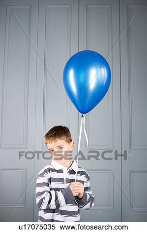 Stock Photography - boy holding balloon. Fotosearch