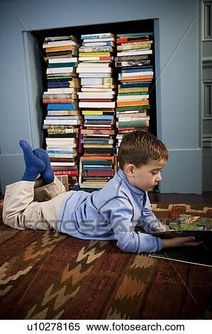 boy looking at picture book on the floor View Large Photo Image Stock Photography - boy looking at picture book on the floor. Fotosearch