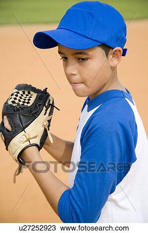 Stock Image - Boy preparing to throw baseball. Fotosearch