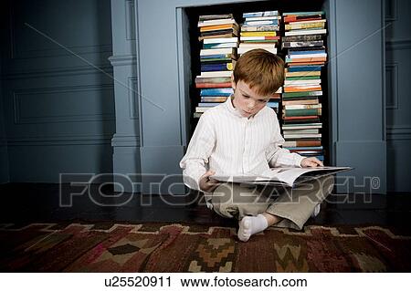 boy reading book sitting on the floor View Large Photo Image Stock Image - boy reading book sitting on the floor. Fotosearch