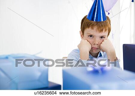 boy sulking at birthday party View Large Photo Image Picture - boy sulking at birthday party. Fotosearch
