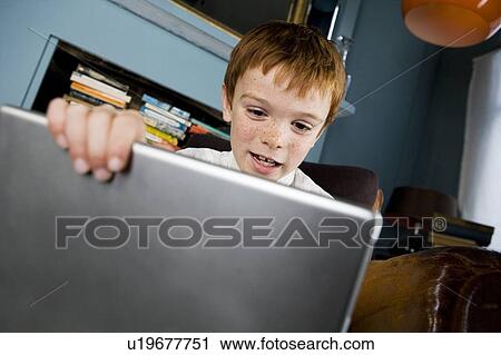 Stock Image - boy using laptop computer. Fotosearch