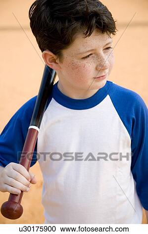 Stock Image - Boy with baseball bat over his shoulder. Fotosearch
