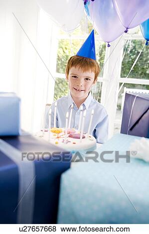 Stock Photo - boy with birthday cake at party. Fotosearch
