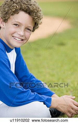 Boy with curly hair sitting on the grass View Large Photo Image Stock Image - Boy with curly hair sitting on the grass. Fotosearch