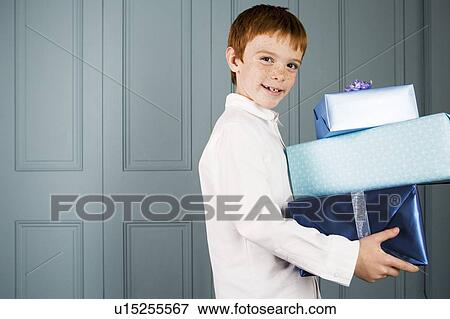 boy with ginger hair carrying presents View Large Photo Image Stock Photo - boy with ginger hair carrying presents. Fotosearch