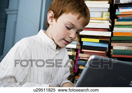 Stock Photography - boy working on laptop. Fotosearch