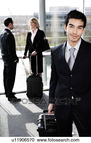 Stock Image - Business people traveling, waiting in airport or station. Fotosearch