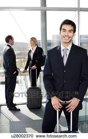 Stock Image - Business people traveling, waiting in airport or station. Fotosearch