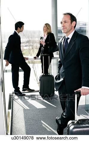 Stock Photo - Business people traveling, waiting in airport or station. Fotosearch