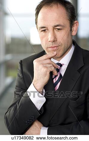 Stock Image - Businessman deep in thought. Fotosearch