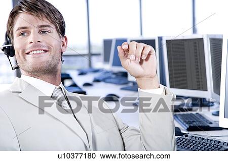 Businessman in a call centre or trading floor View Large Photo Image Stock Image - Businessman in a call centre or trading floor. Fotosearch