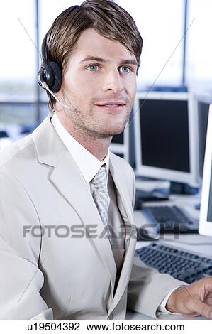 Businessman in a call centre or trading floor View Large Photo Image Stock Image - Businessman in a call centre or trading floor. Fotosearch
