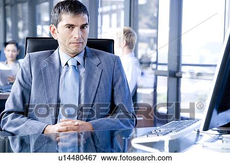 Businessman in a contemporary office View Large Photo Image Stock Photo - Businessman in a contemporary office. Fotosearch