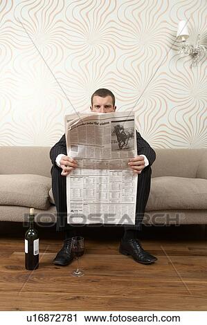 Businessman reading the paper and drinking wine View Large Photo Image Stock Image - Businessman reading the paper and drinking wine. Fotosearch