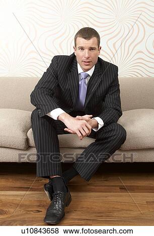 Businessman sitting on sofa View Large Photo Image Stock Photo - Businessman sitting on sofa. Fotosearch