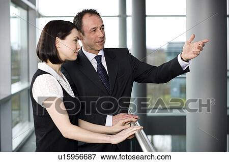 Stock Photo - Businessman with female colleague or client in office. Fotosearch