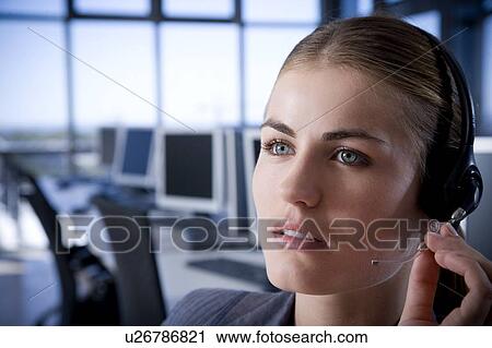 Businesswoman communicating on a call centre headset View Large Photo Image Stock Image - Businesswoman communicating on a call centre headset. Fotosearch