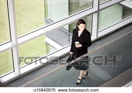 Businesswoman in modern office building, arriving for work View Large Photo Image Stock Image - Businesswoman in modern office building, arriving for work. Fotosearch