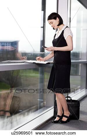 Businesswoman or secretary making an appointment in a diary View Large Photo Image Stock Image - Businesswoman or secretary making an appointment in a diary. Fotosearch