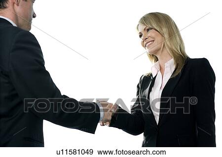 Businesswoman shaking hands with male client or colleague View Large Photo Image Stock Photo - Businesswoman shaking hands with male client or colleague. Fotosearch
