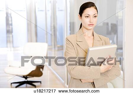 Businesswoman with a laptop looking thoughtful View Large Photo Image Stock Photo - Businesswoman with a laptop looking thoughtful. Fotosearch