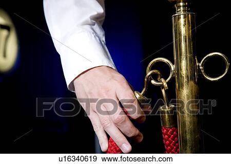Stock Photo - Cinema or theatre usher's hand holding red cordon . Fotosearch