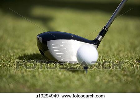 Stock Photo - Close-up of a golf club and ball on a tee. Fotosearch