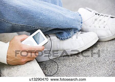 Close up of a man with an MP3 Player View Large Photo Image Stock Image - Close up of a man with an MP3 Player . Fotosearch