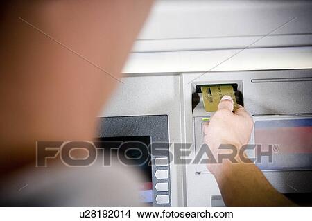 Close up of a young woman using a cashpoint or ATM View Large Photo Image Picture - Close up of a young woman using a cashpoint or ATM. Fotosearch