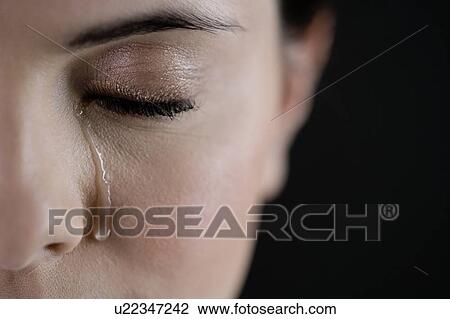 Stock Image - Close up of woman crying. Fotosearch