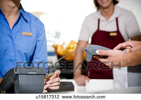 Close up view of a customer paying by credit card in a supermarket View Large Photo Image Stock Image - Close up view of a customer paying by credit card in a supermarket. Fotosearch