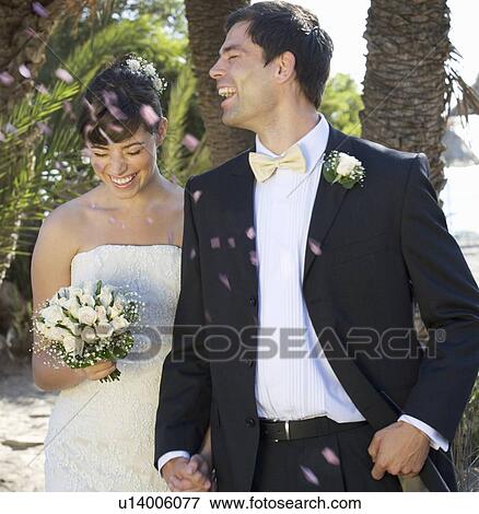 Stock Photo - Confetti over a bride and groom. Fotosearch