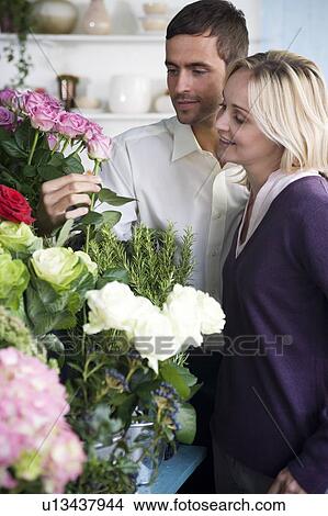Picture - Couple choosing flowers in a florist's shop. Fotosearch