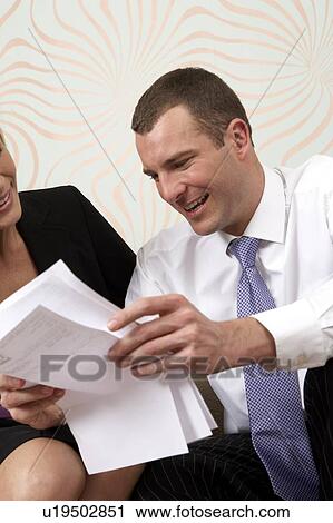 Stock Image - Couple discussing business. Fotosearch