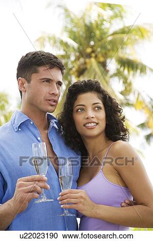 Couple drinking champagne on tropical holiday View Large Photo Image Stock Image - Couple drinking champagne on tropical holiday. Fotosearch