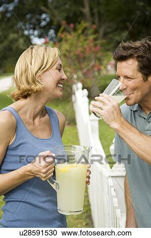 couple in garden with jug of lemonade View Large Photo Image Stock Image - couple in garden with jug of lemonade. Fotosearch