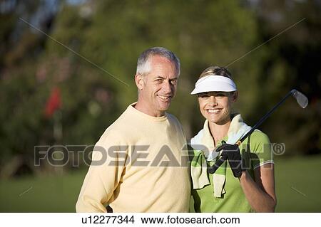 Couple playing golf View Large Photo Image Picture - Couple playing golf. Fotosearch