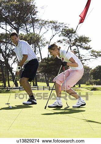 Picture - Couple playing golf. Fotosearch