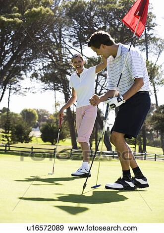 Stock Photo - Couple playing golf. Fotosearch