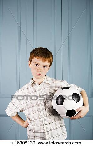 cross little boy holding football View Large Photo Image Stock Photo - cross little boy holding football . Fotosearch