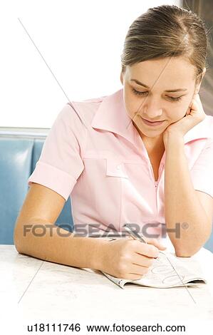 Diner waitress looking at the classified section of a newspaper View Large Photo Image Stock Photograph - Diner waitress looking at the classified section of a newspaper . Fotosearch