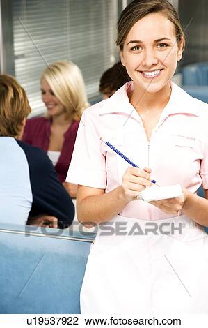 Stock Image - Diner waitress with an order pad and pen. Fotosearch